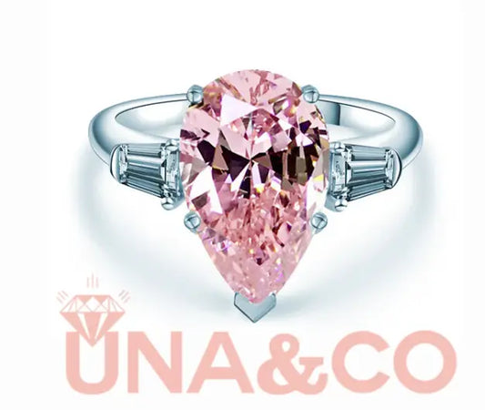 Pear-shaped pink moissanite engagement ring with side stones by UNA&CO